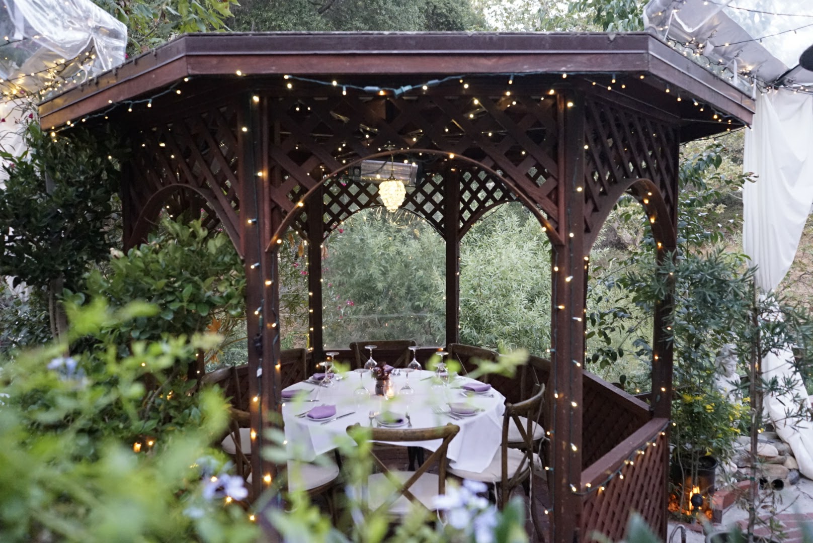 Gazebo dinner table beneath twinkle lights