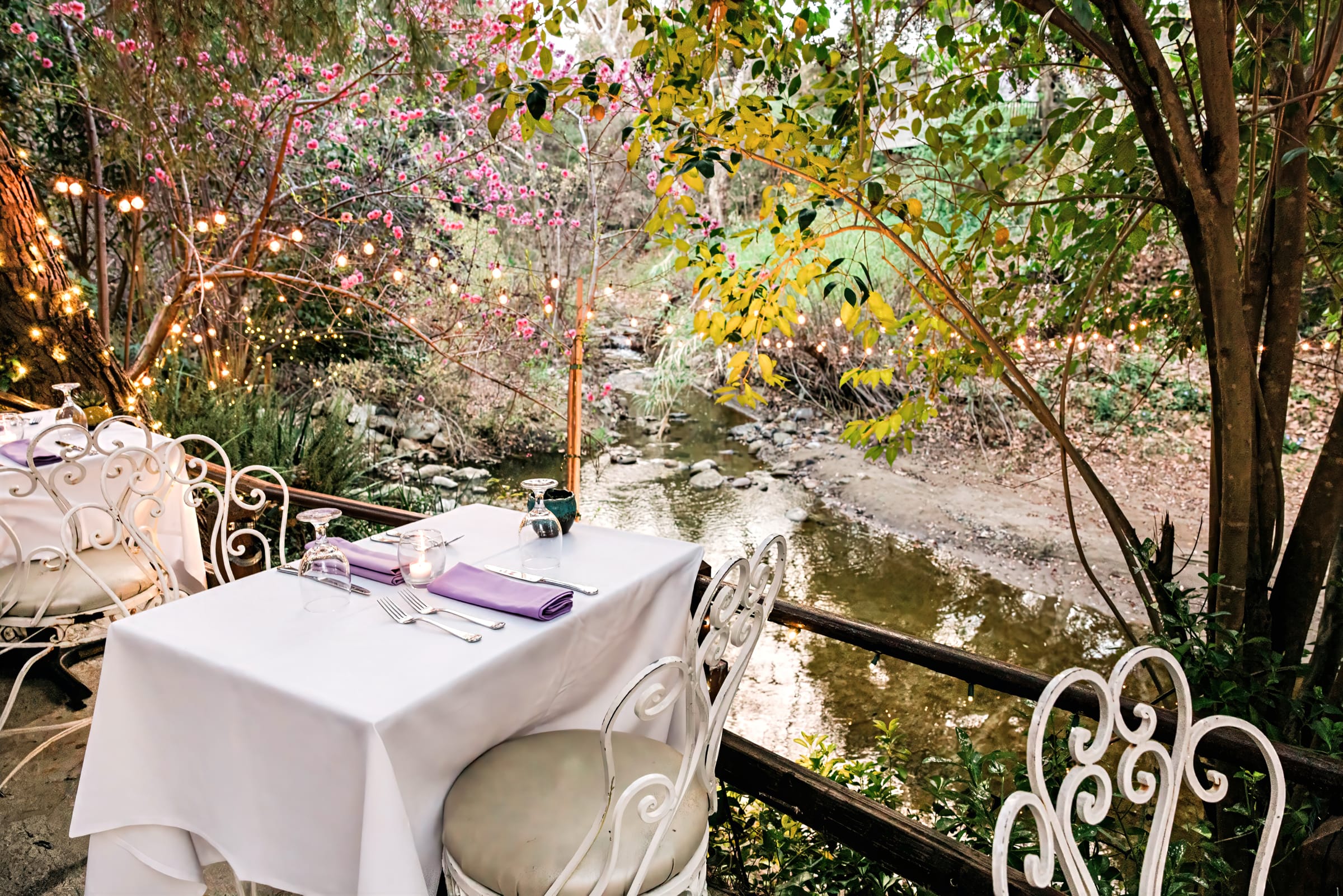 Creekside table for two beside the running creek at Inn of the Seventh Ray